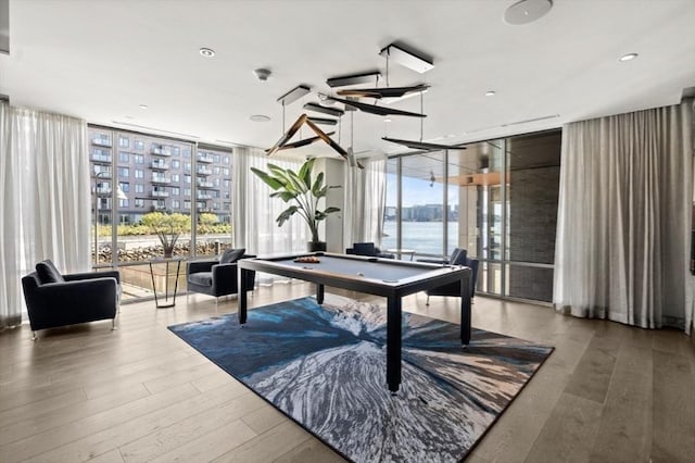 65 Lewis St Unit Ph03, Boston, MA 02128 - playroom with a wall of windows, wood finished floors, a wealth of natural light, and pool table
