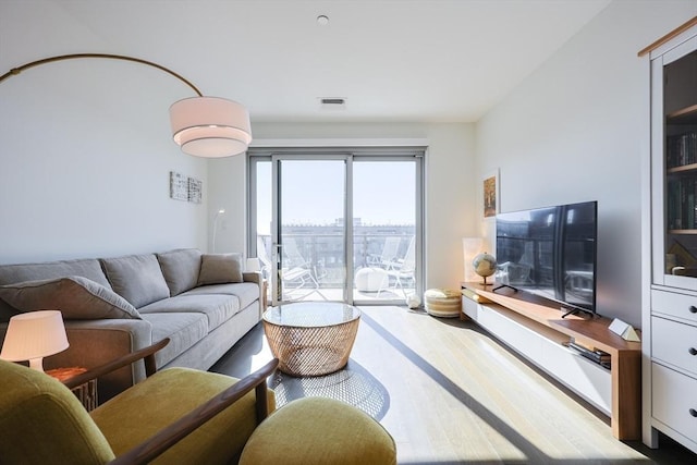 65 Lewis St Unit Ph03, Boston, MA 02128 - living area featuring wood finished floors and visible vents