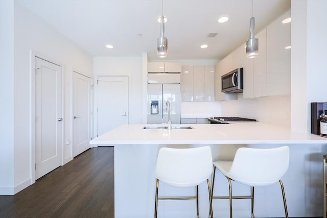 65 Lewis St Unit Ph03, Boston, MA 02128 - kitchen featuring stainless steel microwave, built in refrigerator, a peninsula, light countertops, and a sink