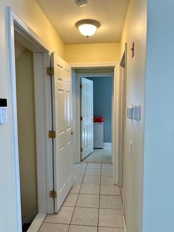 hallway featuring light tile patterned flooring