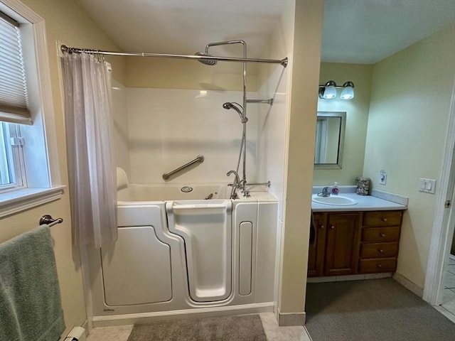 full bath with a healthy amount of sunlight, baseboards, shower / bath combo with shower curtain, and vanity