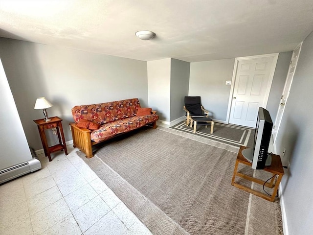 living area with a baseboard heating unit and baseboards