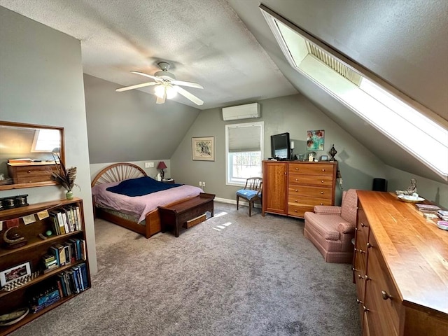 bedroom with carpet, lofted ceiling with skylight, a ceiling fan, a textured ceiling, and a wall mounted air conditioner