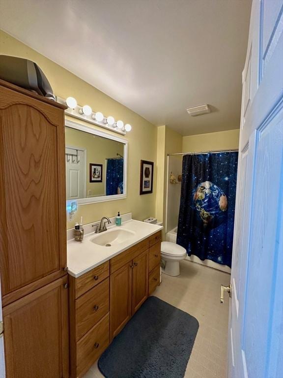 bathroom with vanity, shower / bath combo with shower curtain, and toilet