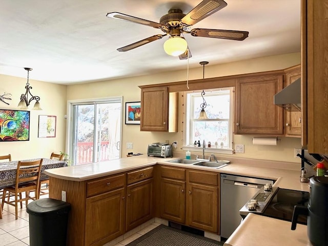 kitchen featuring brown cabinets, stainless steel dishwasher, a sink, ventilation hood, and a peninsula