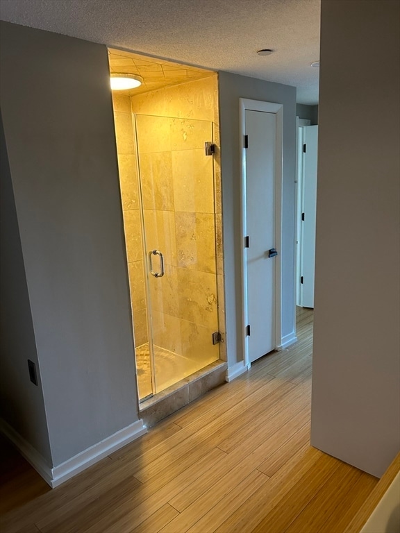 interior space featuring light hardwood / wood-style flooring and a textured ceiling