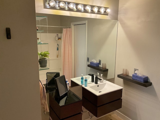 bathroom featuring walk in shower and vanity