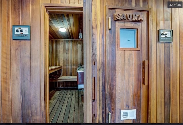 view of sauna with wood walls