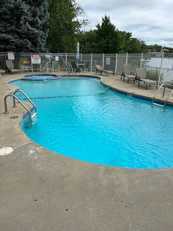 view of pool featuring a hot tub