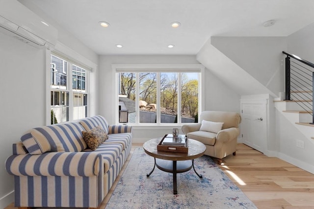 sitting room featuring stairs, recessed lighting, wood finished floors, and a wealth of natural light