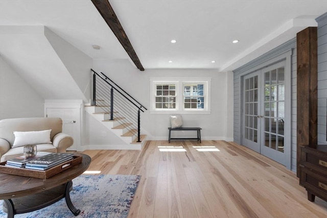 interior space featuring french doors, baseboards, stairs, light wood-style flooring, and a wealth of natural light