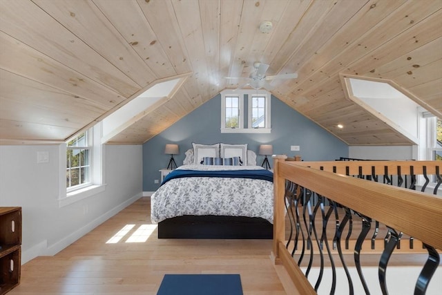 bedroom featuring a ceiling fan, baseboards, wood finished floors, vaulted ceiling, and wood ceiling