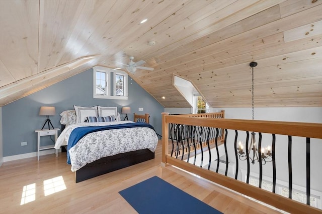 bedroom featuring baseboards, lofted ceiling, wood finished floors, and wooden ceiling