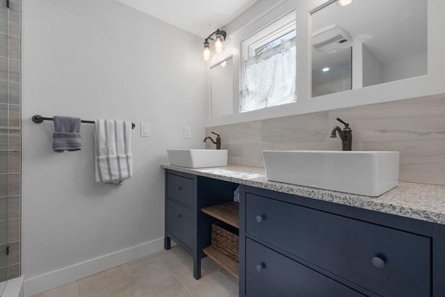 bathroom featuring double vanity, tile patterned floors, a sink, and tasteful backsplash