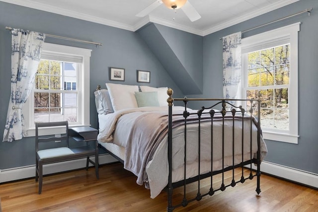 bedroom with ornamental molding, a ceiling fan, wood finished floors, baseboards, and a baseboard radiator