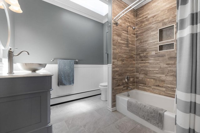 full bathroom with vanity, wainscoting, toilet, baseboard heating, and shower / bath combo