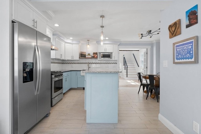 kitchen featuring baseboards, backsplash, white cabinets, and stainless steel appliances