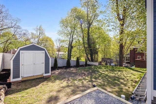 view of yard featuring an outdoor structure, a shed, and fence