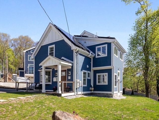view of front of home with board and batten siding and a front lawn