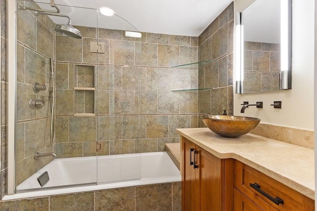 full bathroom with tiled shower / bath combo and vanity