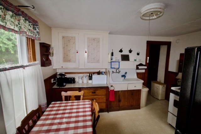 66-R Beach St, Warren, RI 02885 - kitchen with freestanding refrigerator, white cabinetry, light countertops, and range