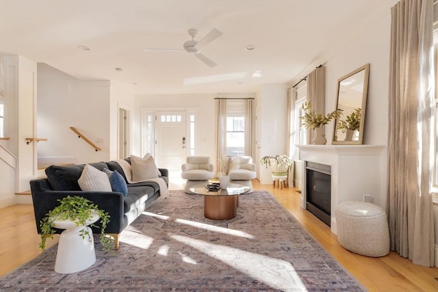 living room with light wood-type flooring and ceiling fan