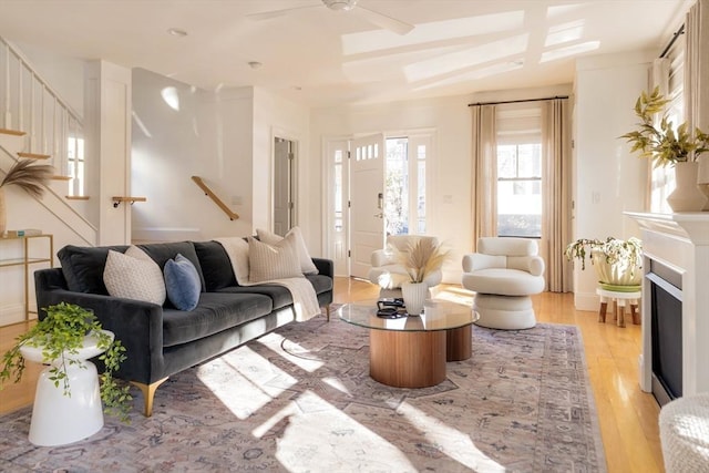 living room with ceiling fan and light wood-type flooring