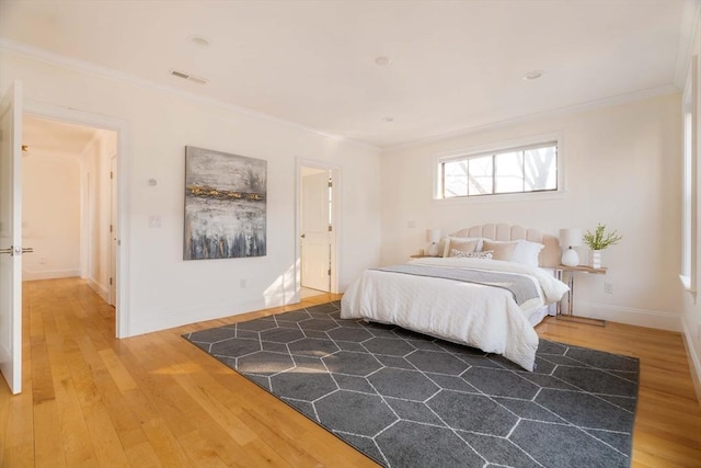 bedroom with crown molding and wood-type flooring