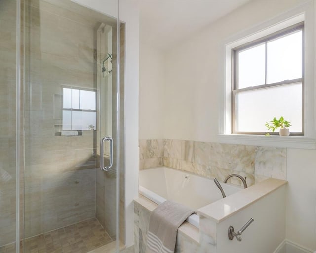 bathroom with separate shower and tub