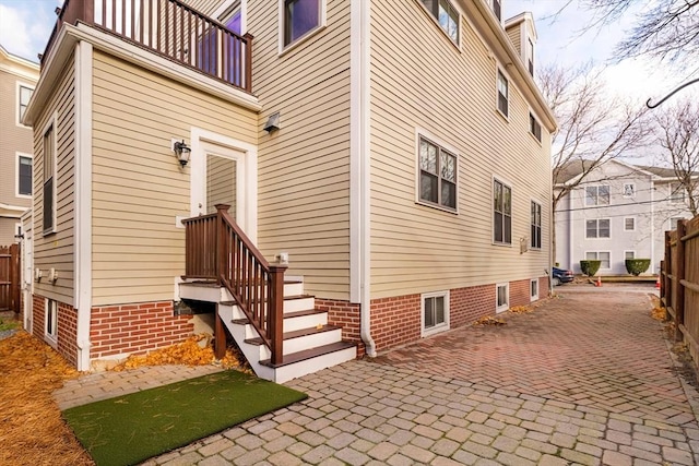 view of side of property featuring a patio area and a balcony