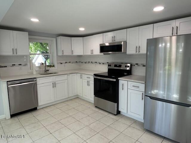 15 Murray Ave, North Adams, MA 01247 - kitchen featuring stainless steel appliances, a sink, decorative backsplash, light countertops, and recessed lighting