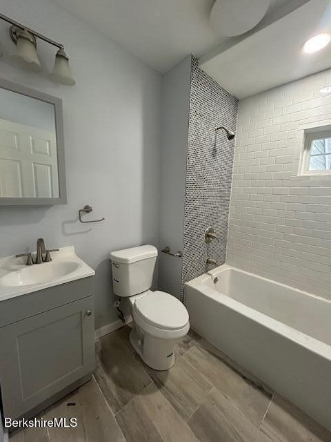 15 Murray Ave, North Adams, MA 01247 - bathroom with toilet, vanity, shower / washtub combination, and wood finish floors