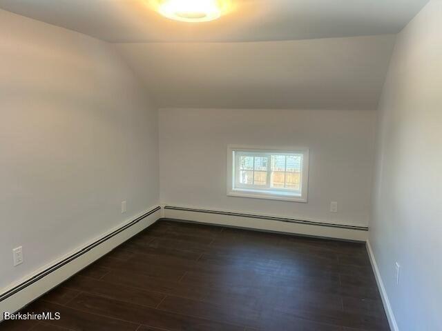15 Murray Ave, North Adams, MA 01247 - unfurnished room featuring a baseboard heating unit, dark wood-style flooring, lofted ceiling, and baseboards