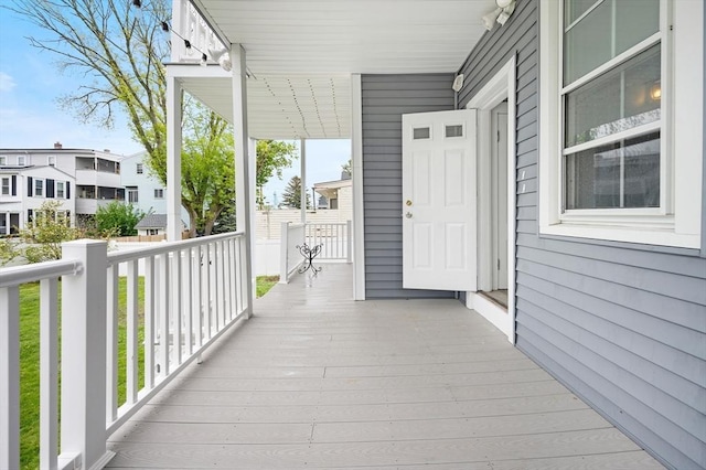wooden deck with covered porch and a residential view