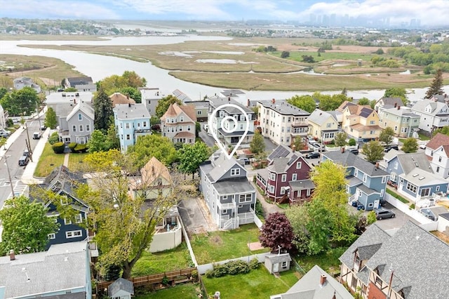 aerial perspective of suburban area featuring a nearby body of water