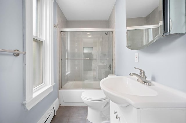 bathroom featuring tile patterned flooring, toilet, bath / shower combo with glass door, vanity, and a baseboard radiator