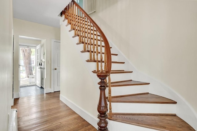 stairs featuring baseboards and wood finished floors