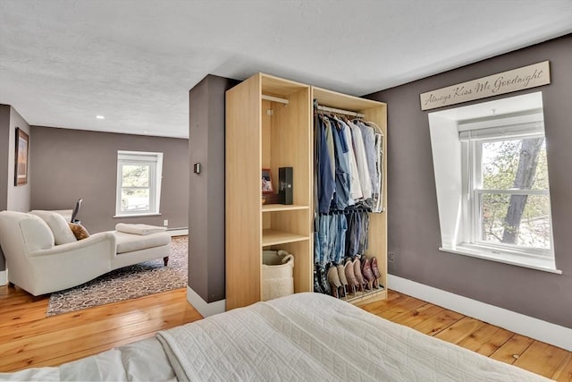 bedroom featuring wood-type flooring and baseboards