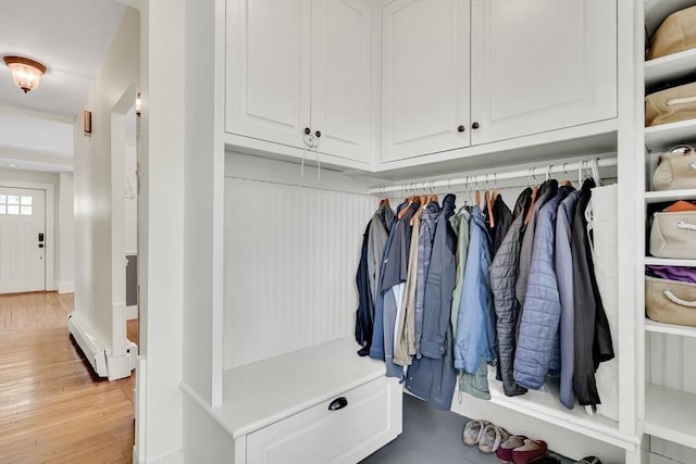 mudroom with a baseboard radiator and wood finished floors