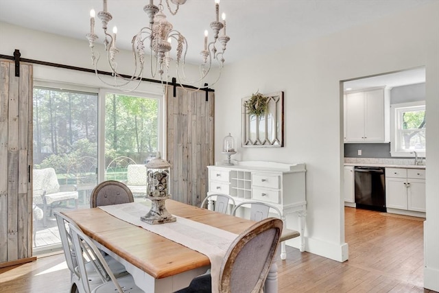 dining area with an inviting chandelier and light wood-style flooring