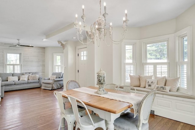 dining space featuring a notable chandelier, plenty of natural light, and light wood-style floors