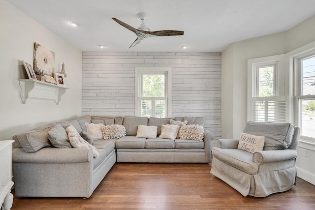 living area with wood finished floors, ceiling fan, and recessed lighting