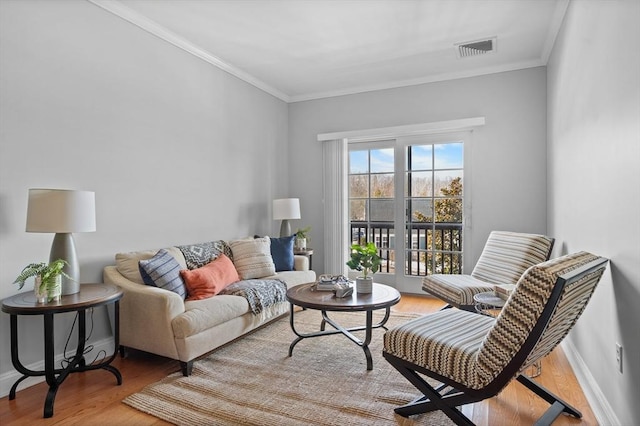 living room featuring hardwood / wood-style floors and ornamental molding