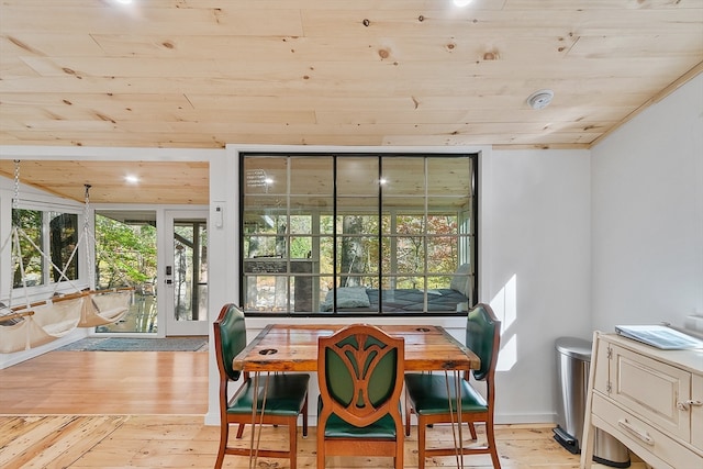 dining area featuring french doors, light hardwood / wood-style floors, and wooden ceiling