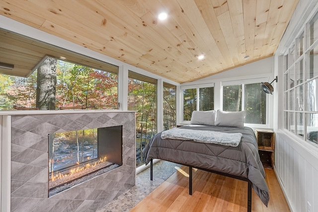 bedroom with vaulted ceiling, multiple windows, and wooden ceiling