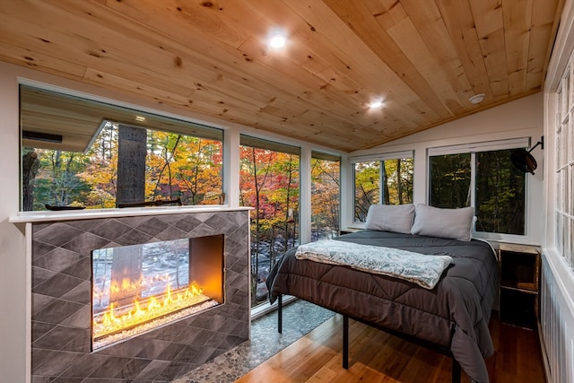 bedroom featuring a fireplace, wood ceiling, lofted ceiling, and wood-type flooring