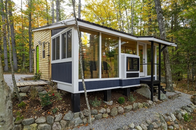 view of outbuilding with a sunroom