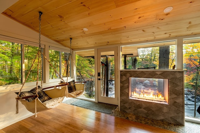 unfurnished sunroom with plenty of natural light, wooden ceiling, and lofted ceiling