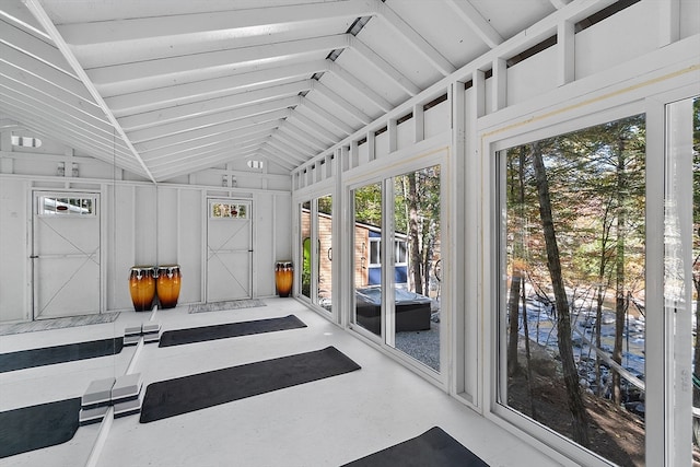 sunroom featuring plenty of natural light and lofted ceiling