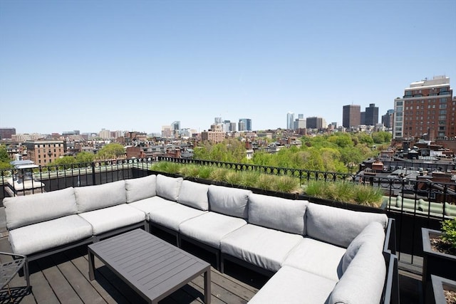 wooden deck featuring outdoor lounge area and a view of skyline